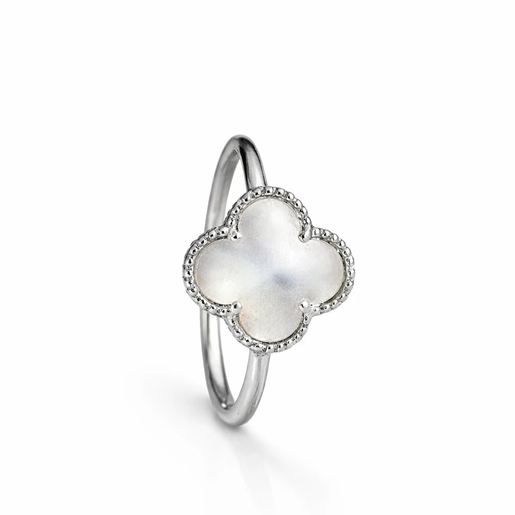 Mother of pearl clover halo ring in 925 sterling silver with sparkling stone border, elegant minimal jewellery for women.